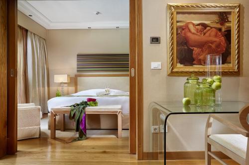 a hotel room with a bedroom with a bed at Rodos Park in Rhodes Town