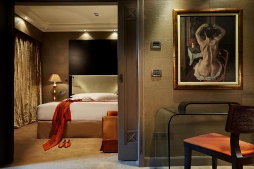 a hotel room with a bed and a painting on the wall at Rodos Park in Rhodes Town