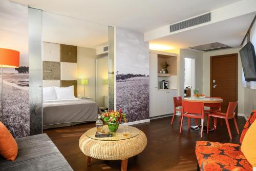 a hotel room with a bed and a table at Sadot Hotel Ben Gurion Airport - an Atlas Boutique Hotel in Assaf Harofeh