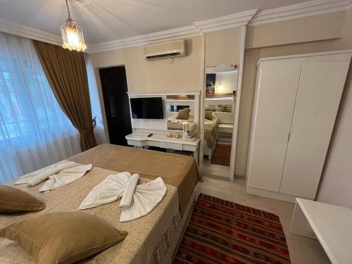 a bedroom with two beds and a living room at YILDIZHAN HOTEL in Pamukkale
