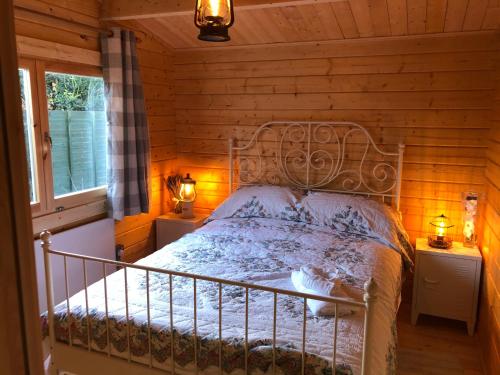 a bedroom with a bed in a log cabin at Beckside Lodge in Malton