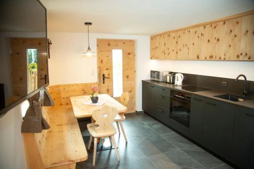 a kitchen with a table and chairs in a room at Innerforchhof in Senales