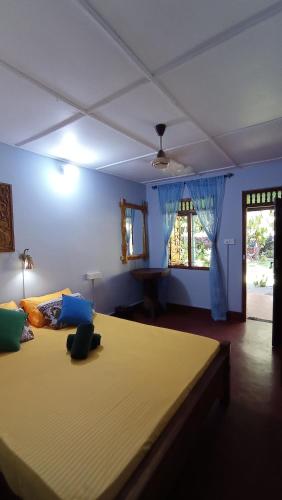 a bedroom with a large bed and a window at Lobster Inn in Trincomalee