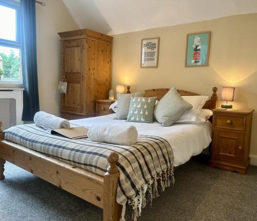 a bedroom with a bed with a book on it at Pinfold Cottage York in York