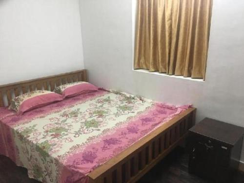 a bedroom with a bed with pink sheets and pink pillows at Shez Holiday Villa Vacation House in Trincomalee in Trincomalee