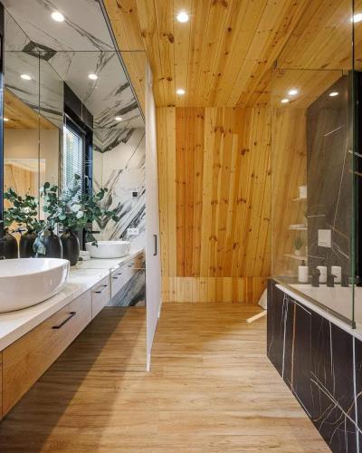 a bathroom with two sinks and two mirrors at RUbuto ABNB in Kigali