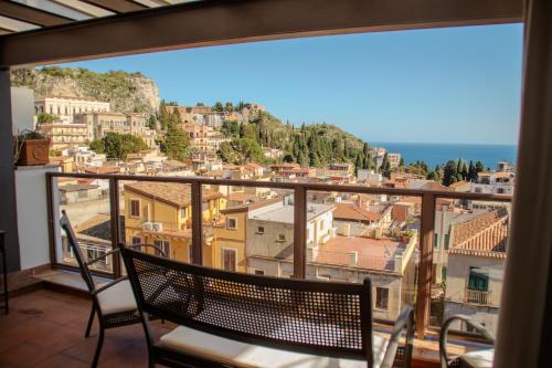 a balcony with a view of a city at Taormina Palazzo di Ferro in Taormina