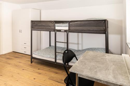 a room with two bunk beds and a table at OR Appartements in Heretsried