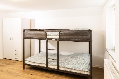 a black bunk bed in a room at OR Appartements in Heretsried