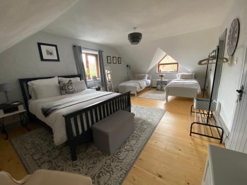 a bedroom with a bed and a living room at Salmon Weir Lodge in Cong