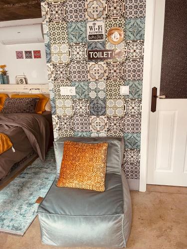 a room with a couch in front of a wall at CASA BOHO your happy place in Calheta in Calheta