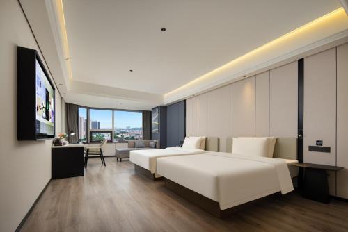 Ένα ή περισσότερα κρεβάτια σε δωμάτιο στο Atour X Hotel Guangzhou Huangpu Nangang Wanda
