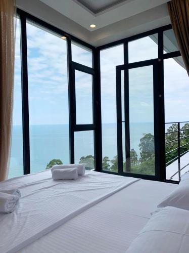 a bedroom with a bed with a view of the ocean at Kvariati Hills Hotel in Kvariati