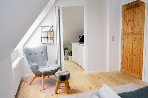 a living room with a chair and a mirror at Vila Ana - 2 room apartment in Vejle