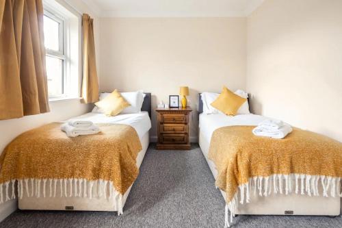 a bedroom with two beds and a window at Spacious 4-bedroom townhouse in the city center with free parking in Oxford