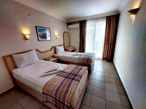 Postel nebo postele na pokoji v ubytování Blue Heaven Apart Hotel
