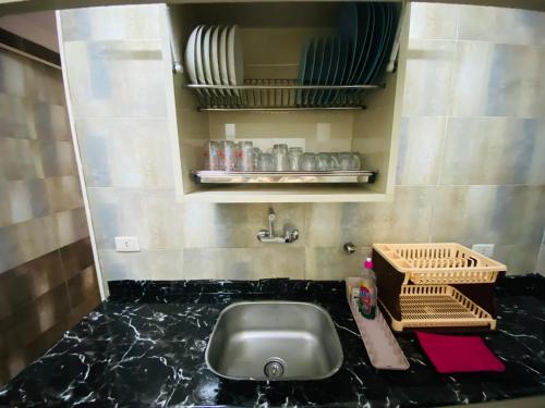 a bathroom with a sink and a counter top at كورنيش النيل البحر الاعظم -Nile corniche albahr alaeizam in Cairo