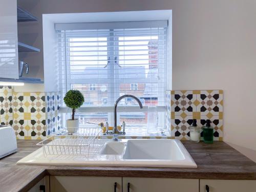 a kitchen counter with a sink and a window at Exclusive 1 Bedroom Retreat in Bicester in Bicester