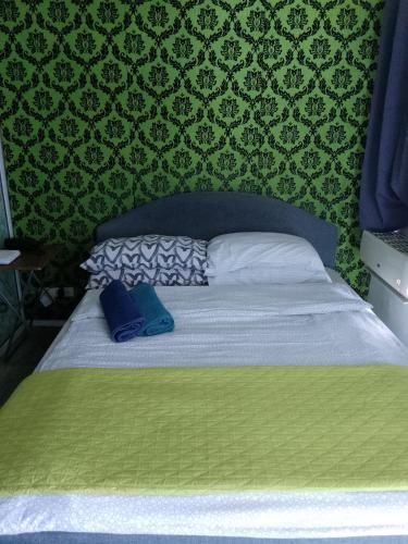 a bed in a bedroom with a green wall at 1bedroom with balcony in Manila