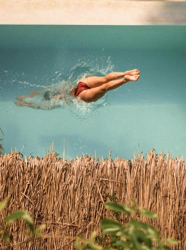 a woman floating in the water in the water at La Playa Beach Club in Hiriketiya