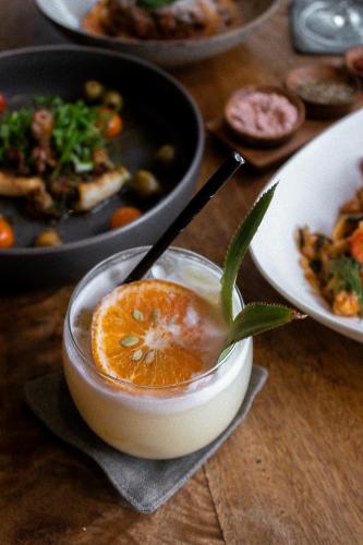 a bowl of food with an orange in it on a table at La Playa Beach Club in Hiriketiya