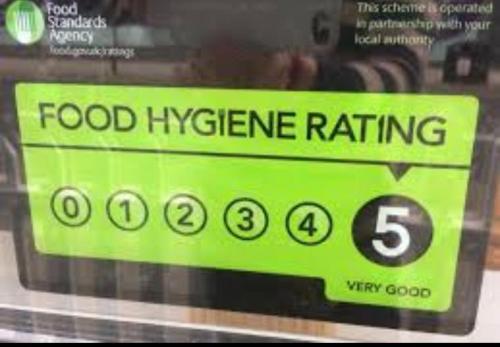 a sign for food hygiene rating in a store window at Meland (Families ONLY B&B) in Blackpool