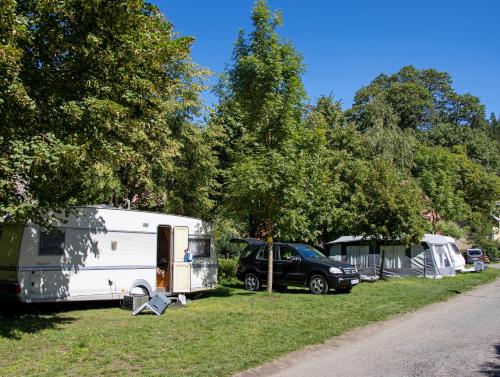 a group of tents and a car parked in a field at Camping Karolina in Planá