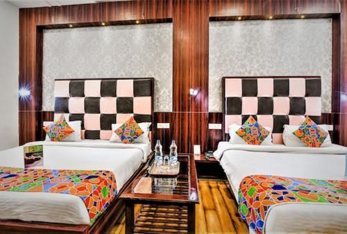 a hotel room with two beds and a table at HOTEL METRO in Lucknow
