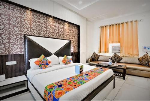 a hotel room with a bed and a couch at HOTEL METRO in Lucknow