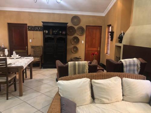 a living room with a couch and a table at The Lemon Tree Self- Catering in Johannesburg