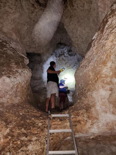 a man and a child standing in a cave at Munsterland Guest Farm in Outjo