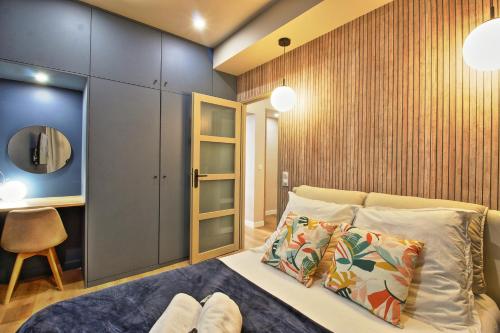 une chambre avec un lit, une chaise et un miroir dans l'établissement 060 - Le Littre - Appartement 1 chambre, Central, Proche Maison carrée, Clim, 4personnes, à Nîmes