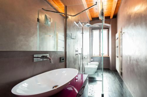 a bathroom with a large white tub and a sink at mirko apartment in Verona