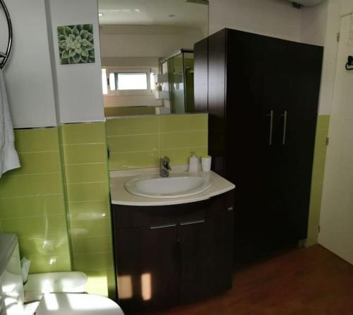 a bathroom with a sink and a toilet and a mirror at Estudio reformado primera linea playa in Sitio de Calahonda