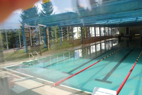 a swimming pool in a building with a swimming pool at Residence Albarè in Mezzana