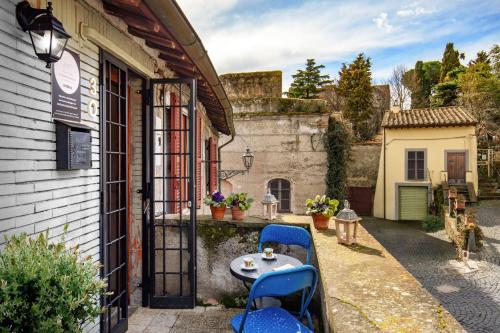 a patio with a table and chairs outside of a building at Centro e Spiaggia ambra in Anguillara Sabazia