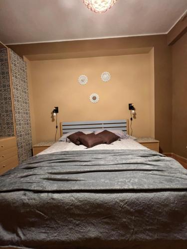 a bedroom with a large bed and a chandelier at Gioia di Mare in Marzamemi