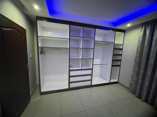 a walk in closet with glass doors in a room at Villa on Dirk Smit Crescent in Alberton