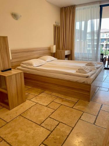a bedroom with a large bed and a window at Lux By Kaliakria in Topola