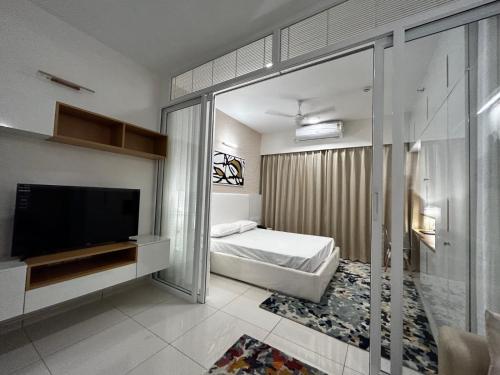 a bedroom with a bed and a television in it at 1 BHK apartment in Bangalore