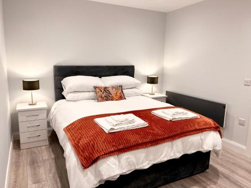 a bedroom with a large bed with a red blanket at Mary McGill’s in Ballycastle