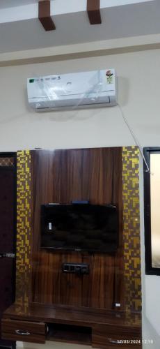 a microwave oven on top of a wooden wall at Hari Har vila house Air conditioner Full vila for rent in Ujjain
