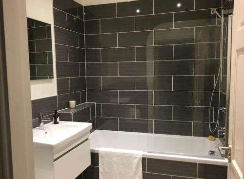 a bathroom with a white tub and a sink at Star Apartment York City Centre - Self Check-in in York