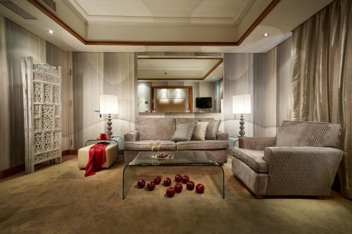 a living room with a couch and a table at Rodos Park in Rhodes Town
