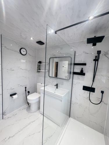 a bathroom with a toilet and a sink and a shower at Home near London Heathrow, Slough,Windsor,Legoland in Colnbrook