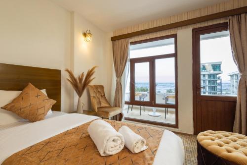 a bedroom with a large bed and a large window at Nish Atakum Otel in Atakum