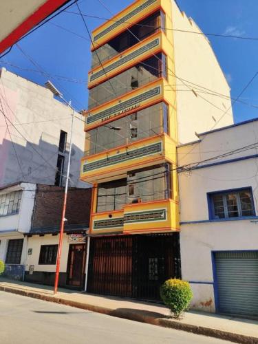 a tall building on the side of a street at COMODORO DEPARTAMENTOS in Oruro