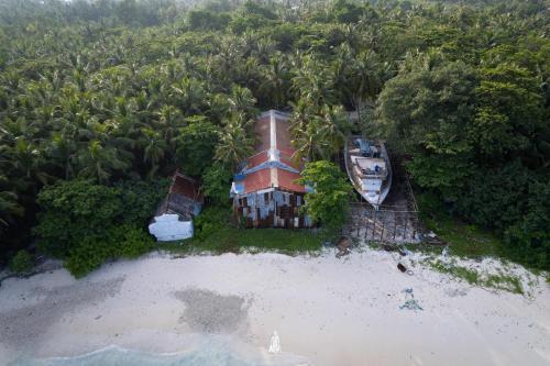 an aerial view of a house on a beach at Dhonveli Hotel in Shaviyani Atoll