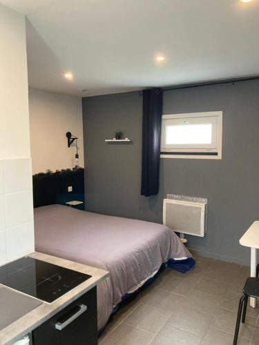 a small bedroom with a bed and a window at Studio in Élincourt