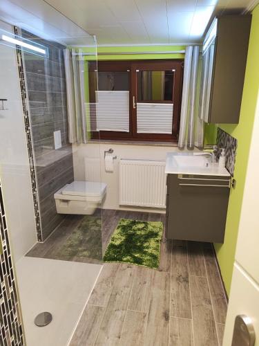 a bathroom with a sink and a toilet at Anke`s Ferienwohnung in Eisenach